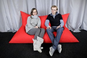 Two young polish entrepreneurs portrait while sitting on one of the large pillows that they produce.