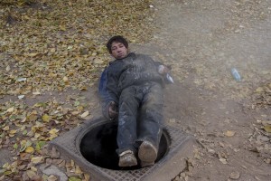 A man is portrayed after the use of aurolac drug near Gara de Nord in Bucharest, Romania on November 6, 2011. During the winter hundreds of persons, sleep in the basement of the city to find heat. 