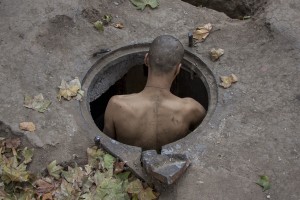 A man called “Bruce Lee” and considered the boss of Gara de Nord, introduce himself in the sewer where he lives in Bucharest, Romania on November 6, 2011. During the winter hundreds of persons, sleep in the basement of the city to find heat. 