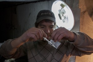 A man prepares a syringe of heroin in a sewer of Bucharest, Romania on November 12, 2011. During the winter hundreds of persons, sleep in the basement of the city to find heat. 