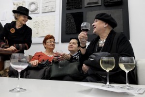 People drinking wine during the opening of an art exhibition at the gallery “Salon Akademii” in Warsaw on February 18, 2014. 