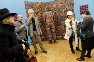 People drinking wine during the opening of an art exhibition at the gallery “Salon Akademii” in Warsaw on February 18, 2014. 