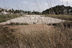 Some kids playing football in a soccer field near the port of Tunis on October 20, 2012.