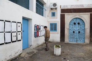 A man looks at the election posters on a wall in Tunis on November 13, 2014.