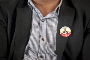 A man with a brooch of the leader of Popular Front, spokesman of the Tunisian Workers’ Party and presidential candidate Hamma Hammami during a meeting held at Sports palace in the Olympic city of El Menzah in Tunis on November 16, 2014.