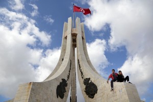 Two children sitting on the memorial to  Tunisians martyrs in place de la Kasbah in Tunis on November 13, 2014.