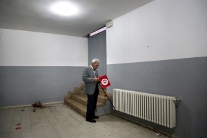 A man smokes a cigarette inside the sports palace in the Olympic city of El Menzah after the campaign meeting of  Beji Caid Essebsi, Tunisian leader of the main anti-Islamist party Nidaa Tounes and presidential candidate in Tunis on November 15, 2014. 