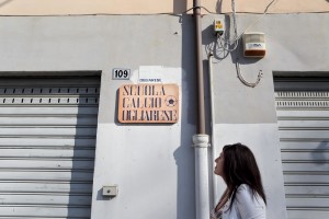Marina Rinaldi looks at a plate of Ogliarese, the first football school where she played when was a child in Rufoli, south Italy, on March 1, 2015. Marina Rinaldi is the first ex trans in the world to coach a soccer team.