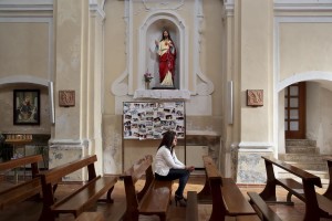 Marina Rinaldi prays in a church before the championship match against Pro Casolla in Rufoli, south Italy, on March 1, 2015. Marina Rinaldi is the first ex trans in the world to coach a soccer team.