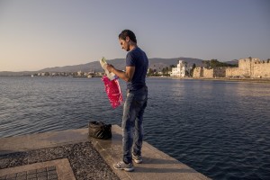 A Syrian migrant consults a map after being caught by the Greek Coast Guard teams in Kos island, Greece on June 14, 2015.