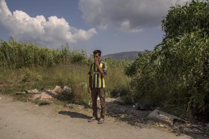An afghan migrant smokes outside an abandoned hotel where many migrants sleep in Kos island, Greece on June 8, 2015. Many migrants are continuing to arrive on the Greek Island of Kos from Turkey. The Island has recently seen a drop in tourist numbers which has been attributed to negative reports on the migrant crisis that is continuing to grip the area. Around 30,000 migrants have entered Greece so far in 2015, with the country calling for more help from its European Union counterparts.