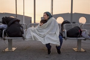 An Afghan woman from the city of Sivas waits with her son to board a ferry bound for Athens in Kos island, greece on June 12, 2015. Many migrants are continuing to arrive on the Greek Island of Kos from Turkey. The Island has recently seen a drop in tourist numbers which has been attributed to negative reports on the migrant crisis that is continuing to grip the area. Around 30,000 migrants have entered Greece so far in 2015, with the country calling for more help from its European Union counterparts.