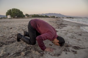 A Pakistani migrant prays after arriving on the beach in a dinghy at dawn after making his way from Turkey in Kos island, Greece on June 15, 2015. Many migrants are continuing to arrive on the Greek Island of Kos from Turkey. The Island has recently seen a drop in tourist numbers which has been attributed to negative reports on the migrant crisis that is continuing to grip the area. Around 30,000 migrants have entered Greece so far in 2015, with the country calling for more help from its European Union counterparts.