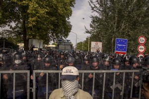 A migrant is seen in front of Hungarian anti-riot police at the Serbian border with Hungary in Horgos, Serbia on September 16, 2015. Hungary’s border with Serbia has become a major crossing point into the European Union, with more than 160,000 access Hungary so far this year.