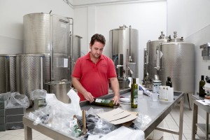 August 10, 2015 – Racale, Italy: Federico Manni, member of the Agricultural Society Cooperative “Acli Racale”, bottles olive oil. 