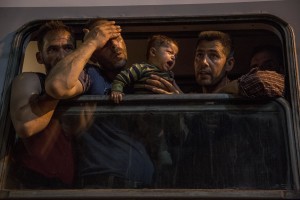 A man is in despair while his son cries after they have boarded on a train used by migrants to reach Zagreb and continue their journey to the North Europe at Tovarnik train station in Tovarnik, Croatia on September 18, 2015.