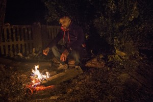 Tovarnik, Croatia: A migrant sits down beside fire after heavy rain at Tovarnik train station in Tovarnik, Croatia on September 20, 2015.
