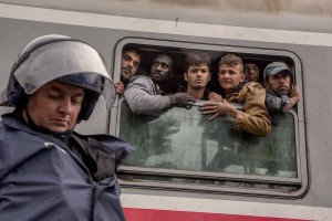 Tovarnik, Croatia: Police guard a train heading for Zagreb as migrants desperately try to continue their journey in the north of Europe despite moves by Slovenia and Hungary to hold them back in Tovarnik, Croatia on September 20, 2015.