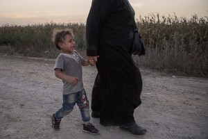 A mother carries her son who cries in a camp near the croatian border with Serbia in Tovarnik, Croatia on September 17, 2015.