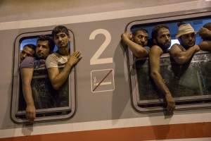 Migrants get on a train to reach Zagreb and continue their journey to the North Europe at Tovarnik train station in Tovarnik, Croatia on September 18, 2015.