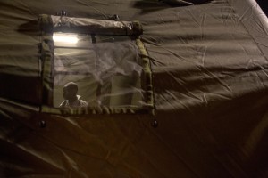 A migrant in poor health is seen inside a tent of Italian Red cross after the arrival of the Norwegian ship “Siem Pilot Stavanger” with 810 refugees at Manfredi pier of Salerno port in Salerno on August 2, 2016. The ship carrying migrants coming mostly from Sudan, Nigeria, Syria and Egypt.