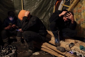 January 29, 2016 – Grande-Synthe, France: Migrants recharge their phones in a tent of Grande-Synthe refugee camp near Dunkirk, northern France, known as “The Jungle 2″. Around 3,000 refugees and migrants of Kurdish descent from Iraq and Syria live in the camp.