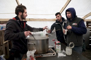 January 29, 2016 – Grande-Synthe, France: Migrants get tea by a volunteer in a tent of the refugee camp of Grande-Synthe near Dunkirk, northern France, known as “The Jungle 2″. Around 3,000 refugees and migrants of Kurdish descent from Iraq and Syria live in the camp.