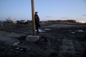 January 28, 2016 – Calais, France: A migrant is seen outside the refugee camp of Calais, known as “The Jungle”. While migrants have for years sought to cross over to Britain from Calais, the numbers have shot up since the refugee crisis went into overdrive last year.