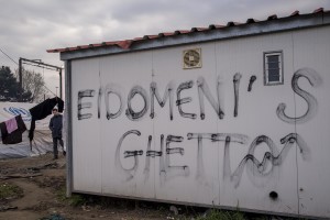 A migrant walks in the refugee camp along the border of Greece and Macedonia near the town of Idomeni in Greece on March 18, 2016. The refugees are being stopped from moving beyond Greece and have been languishing in the rain, mud, and cold with insufficient food and medical care while sleeping in small tents.