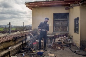 A migrant is seen inside an abandoned house near the makeshift camp of Idomeni at the Greek Macedonian border where thousands of migrants and refugees are stranded in Idomeni, Greece on March 17, 2016.