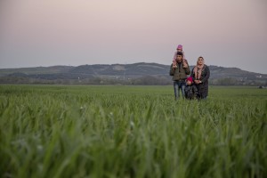 A refugee family stand in a field at a makeshift camp near the village of Idomeni at the Greek-Macedonian border where thousands of migrants are stranded in Idomeni, Greece on March 20, 2016.
