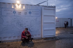 A migrant is seen outside a public bathroom where a map of Europe is posted in the makeshift camp at the Greek-Macedonian border near the village of Idomeni in Greece on March 17, 2016. Refugees’ “journey of hope” towards Western European countries where they dream of having a better life ends in the Balkans following the latest deal between Turkey and EU.