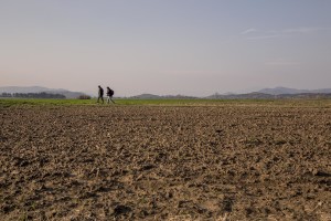 Migrants walk in a camp along the border of Greece and Macedonia near the town of Idomeni, Greece on March 19, 2016. The refugees are being stopped from moving beyond Greece and have been languishing in the rain, mud, and cold with insufficient food and medical care while sleeping in small tents.