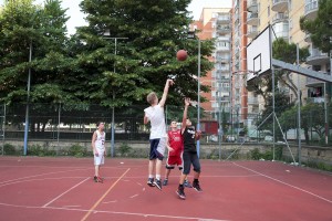 June 8, 2016 – Naples, Italy: Boys playing basketball inside “Corto Maltese” park in Scampia district. Since three years a group of citizens called “Pollici Verdi” take care of “Corto Maltese” pak and self-tax with about 10 euro per month each, with the goal of saving the municipal gardens from degradation.