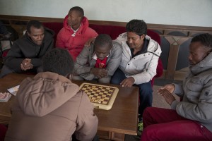 MONTESANO, ITALY – NOVEMBER 12: Migrants play checkers inside Hotel Rendez-Vous where about 40 migrants are hosted in Puglia, Southern Italy on November 12, 2016.