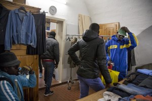 TRICASE, ITALY – NOVEMBER 12: Migrants are seen while they are looking for clothes inside the Caritas of Sant’ Antonio da Padova Church in Puglia, Southern Italy on November 12, 2016.