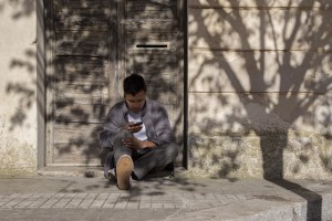 LECCE, ITALY – NOVEMBER 13: A migrant is seen outside the train station of Lecce where a lot of migrants sleep during the night, because of the lack of facilities that could accommodate them in Puglia, Southern Italy on November 13, 2016.