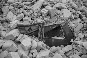 LAZIO, ITALY – AUGUST 24: A car crushed by rubble after a strong earthquake hit Amatrice on August 24, 2016. Italy was struck by a powerful, 6.2-magnitude earthquake in the night, which has killed at least 297 people and devastated dozens of houses in the Lazio village of Amatrice.