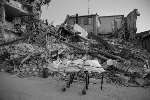 LAZIO, ITALY – AUGUST 24: The body of a person dead is seen on a stretcher after a strong earthquake hit Amatrice on August 24, 2016. Italy was struck by a powerful, 6.2-magnitude earthquake in the night, which has killed at least 297 people and devastated dozens of houses in the Lazio village of Amatrice.