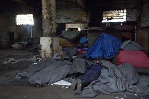 A migrant sleeps on the ground of an abandoned warehouse where he and other migrants took refuge in Belgrade, Serbia on February 4, 2017. Hundreds of migrants have been sleeping in freezing conditions in central Belgrade looking for ways to cross the heavily guarded EU borders.