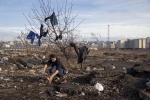 A refugee washes his foot outside an abandoned warehouse where he and other migrants took refuge in Belgrade, Serbia on February 5, 2017. Hundreds of migrants have been sleeping in freezing conditions in central Belgrade looking for ways to cross the heavily guarded EU borders.