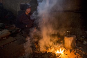 A migrant rests around a fire to warm himself from the cold in an abandoned warehouse in Belgrade, Serbia on February 3, 2017. Hundreds of migrants have been sleeping in freezing conditions in downtown Belgrade looking for ways to cross the heavily guarded EU borders.