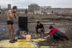 Refugees shower outside an abandoned warehouse where they took refuge in Belgrade, Serbia on February 3, 2017. Hundreds of migrants have been sleeping in freezing conditions in central Belgrade looking for ways to cross the heavily guarded EU borders.