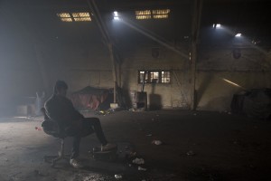 A migrant rests on a chair inside an abandoned warehouse in Belgrade, Serbia on February 3, 2017. Hundreds of migrants have been sleeping in freezing conditions in downtown Belgrade looking for ways to cross the heavily guarded EU borders.