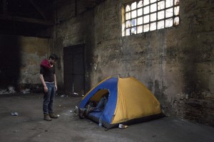 Migrants enter in a tent inside an abandoned warehouse in Belgrade, Serbia on February 3, 2017. Hundreds of migrants have been sleeping in freezing conditions in downtown Belgrade looking for ways to cross the heavily guarded EU borders.