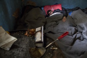 A migrant sleeps on the ground of an abandoned warehouse where he and other migrants took refuge in Belgrade, Serbia on February 5, 2017. Hundreds of migrants have been sleeping in freezing conditions in central Belgrade looking for ways to cross the heavily guarded EU borders.