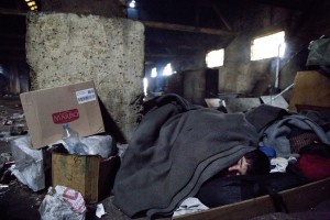 A migrant sleeps on the ground of an abandoned warehouse where he and other migrants took refuge in Belgrade, Serbia on February 4, 2017. Hundreds of migrants have been sleeping in freezing conditions in central Belgrade looking for ways to cross the heavily guarded EU borders.