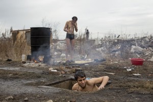 Migrants prepare for shower outside an abandoned warehouse where they took refuge in Belgrade, Serbia on February 3, 2017. Hundreds of migrants have been sleeping in freezing conditions in central Belgrade looking for ways to cross the heavily guarded EU borders.