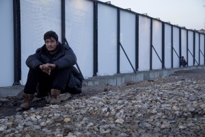 Migrants rest outside an abandoned warehouse where he and other migrants took refuge in Belgrade, Serbia on February 4, 2017. Hundreds of migrants have been sleeping in freezing conditions in central Belgrade looking for ways to cross the heavily guarded EU borders.