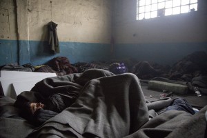 A migrant sleeps on the ground of an abandoned warehouse where he and other migrants took refuge in Belgrade, Serbia on February 3, 2017. Hundreds of migrants have been sleeping in freezing conditions in central Belgrade looking for ways to cross the heavily guarded EU borders.